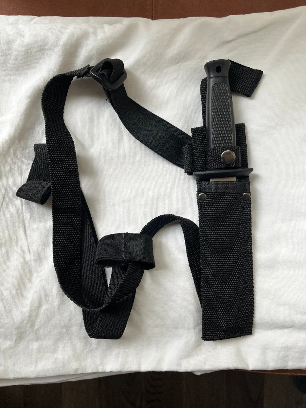 Knife with over the shoulder harness.